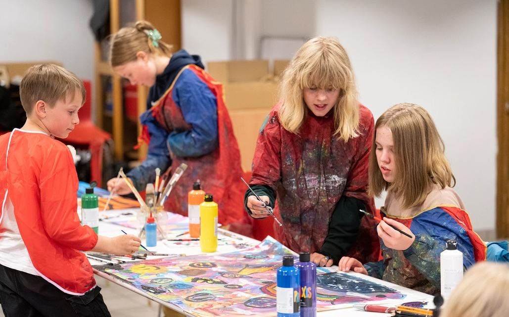 Images of children painting in the museum family workshop.