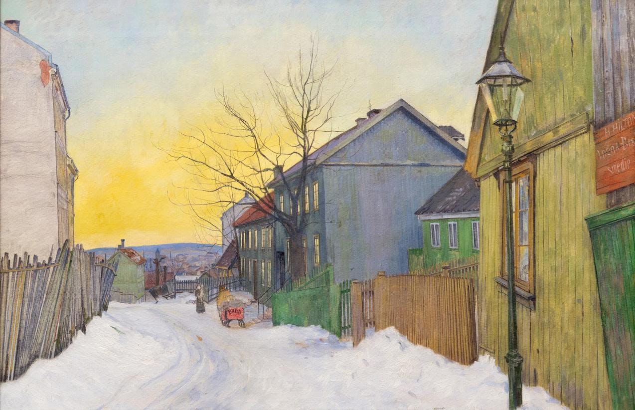 A painting by Harald Sohlberg depicting Sagene in Oslo in the early 1900s. The motif is a winter morning street-view, with a snow covered street and small wooden houses. The sky is clear with a bleak morning sun ascending from the city horizon. 