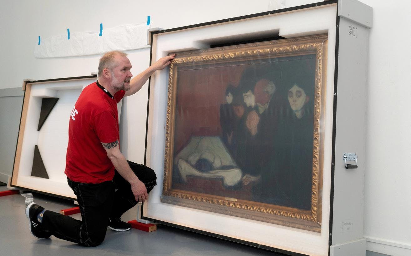 A museum technician preparing a painting by Edvard Munch for transport.